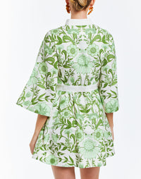Green floral printed mini dress with butterfly sleeves and mandarin collar. Featuring side pockets and a front bow detail.