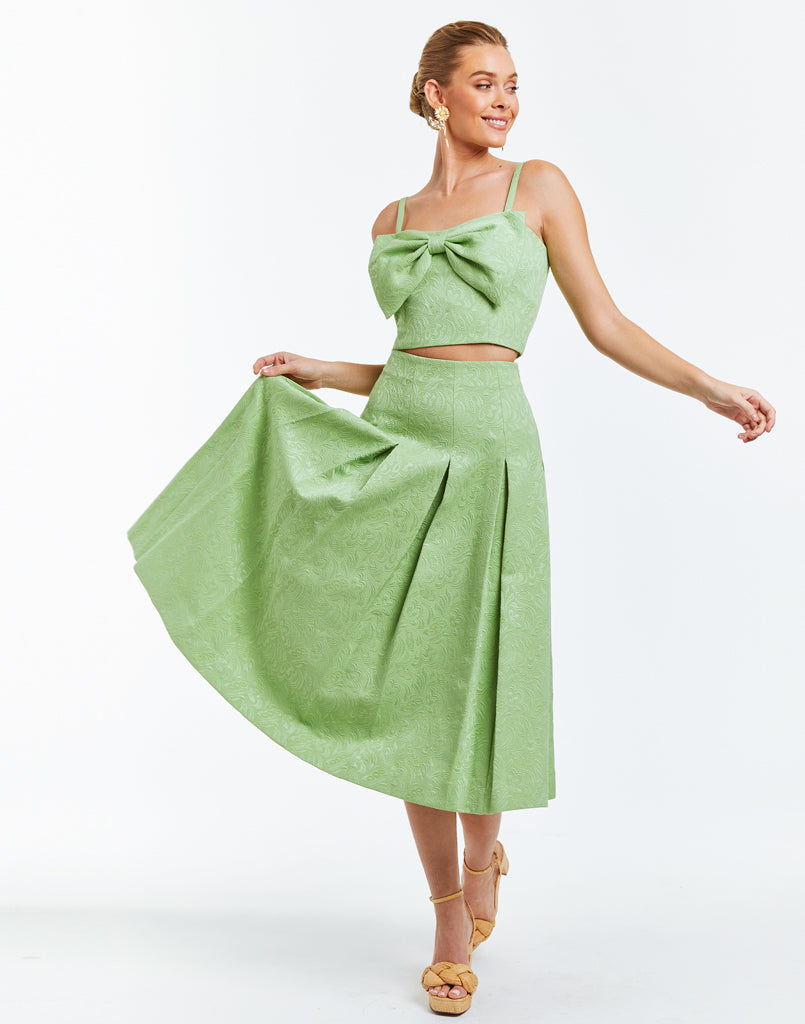 Midi length green jacquard A-line daytime skirt with box pleats. 