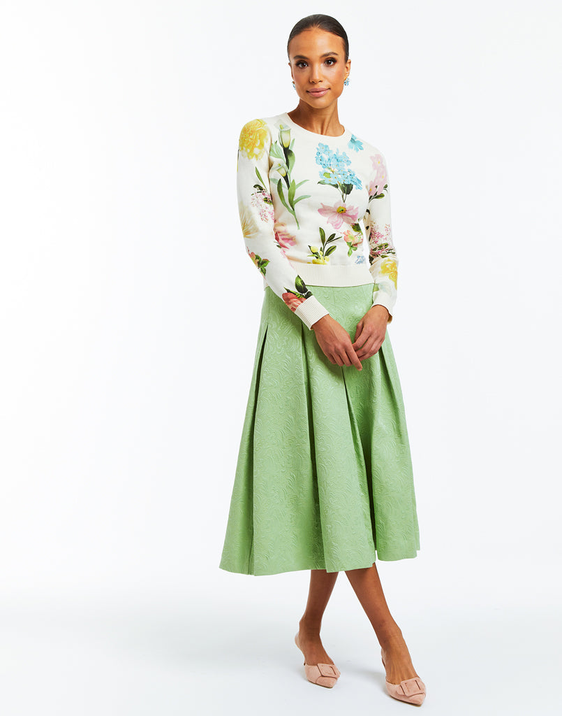 Midi length green jacquard A-line daytime skirt with box pleats. 
