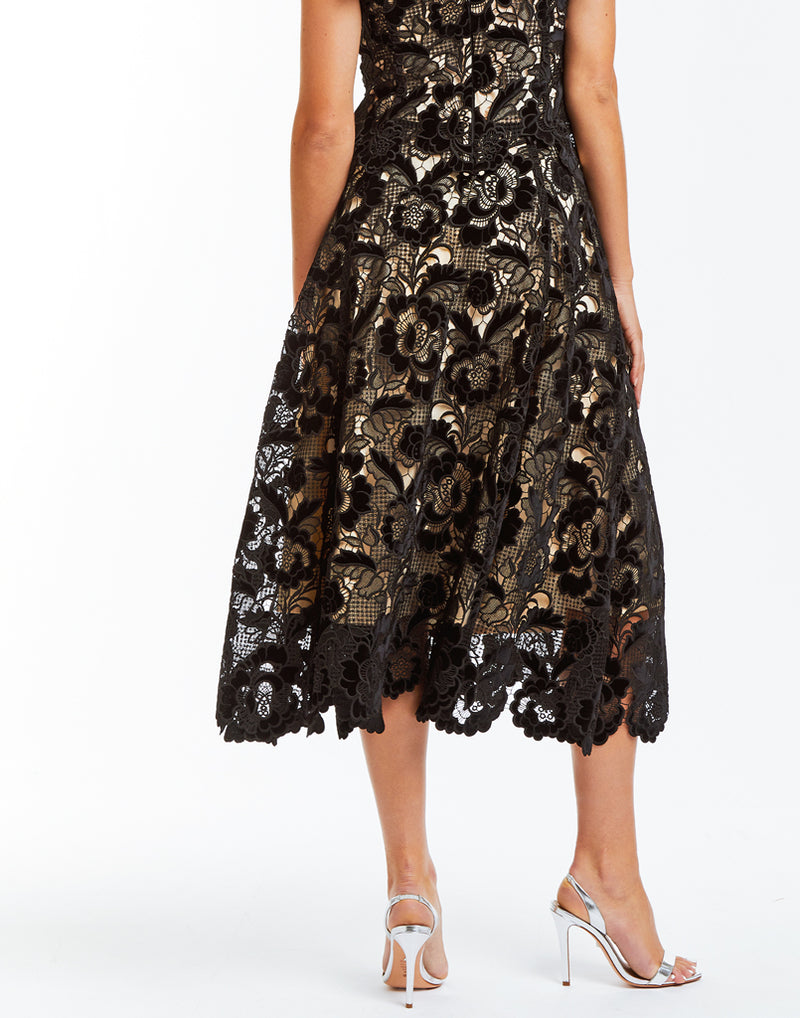 Black velvet laser cut lace skirt with natural scalloped hemline and side pockets. 