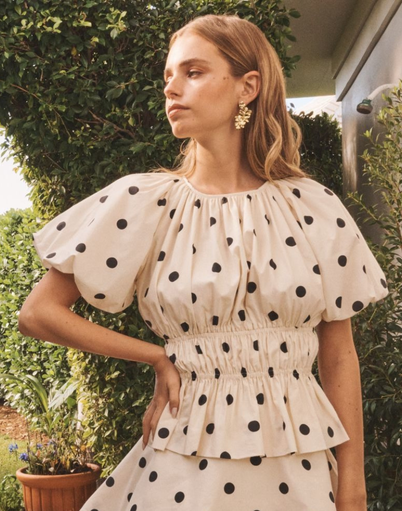 Breakfast Smocked Top in Polka Dot poplin with boat neckline, smocked bodice, balloon sleeves, and peplum hem.