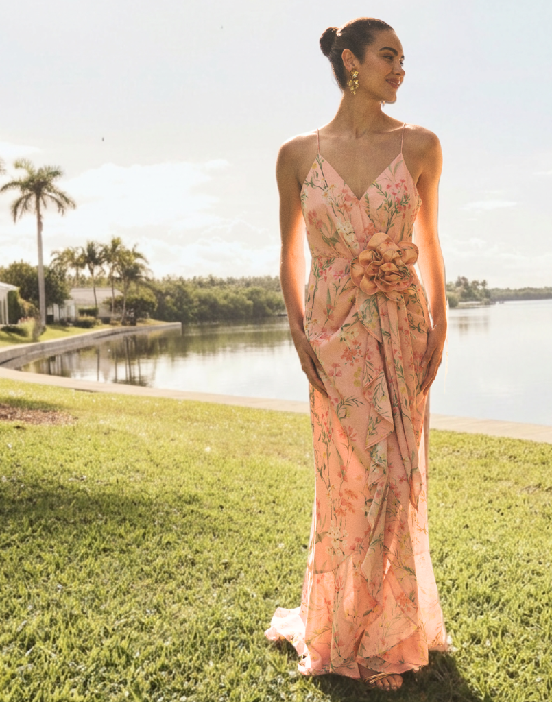 Love Letter Gown in Rose Vines chiffon with cascading ruffle skirt, rosette waist appliqué, adjustable spaghetti straps, and V-neckline.
