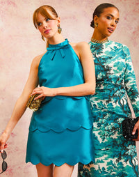 Cannes Convertible Mini Dress in Celestial Blue front – tiered scalloped cocktail dress with halter bow neckline, versatile Convertible™ style by Mestiza New York.
