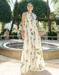 Adelina Gown in Wisteria Toile stretch crepe with halter neckline, cascading bow back detail, A-line silhouette, and hidden side pockets.