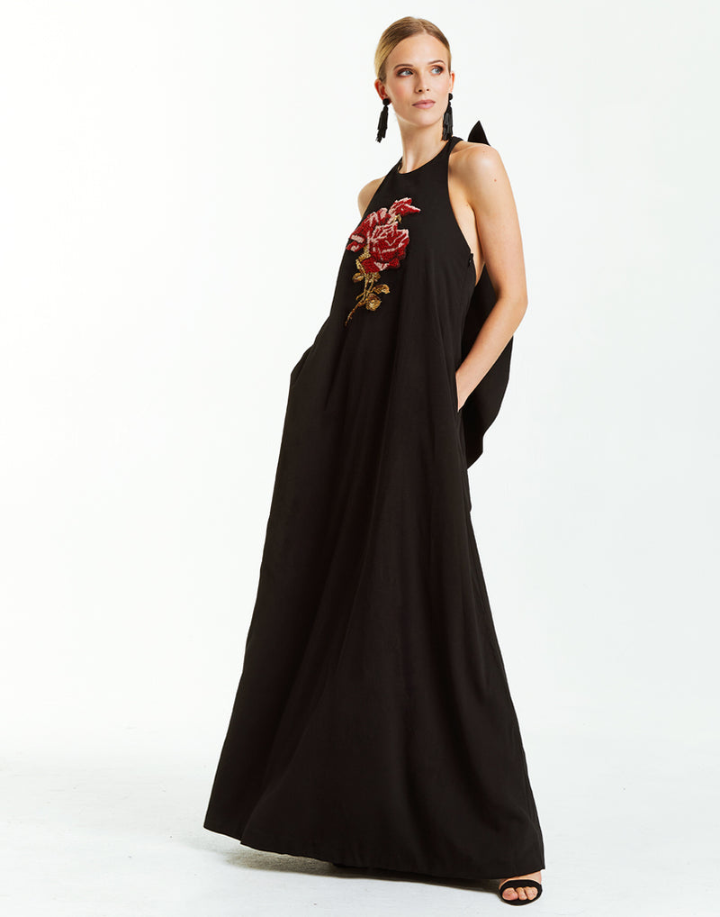 Black crepe maxi halter dress with cascading back ruffle and beaded  rose embellishment on front. 