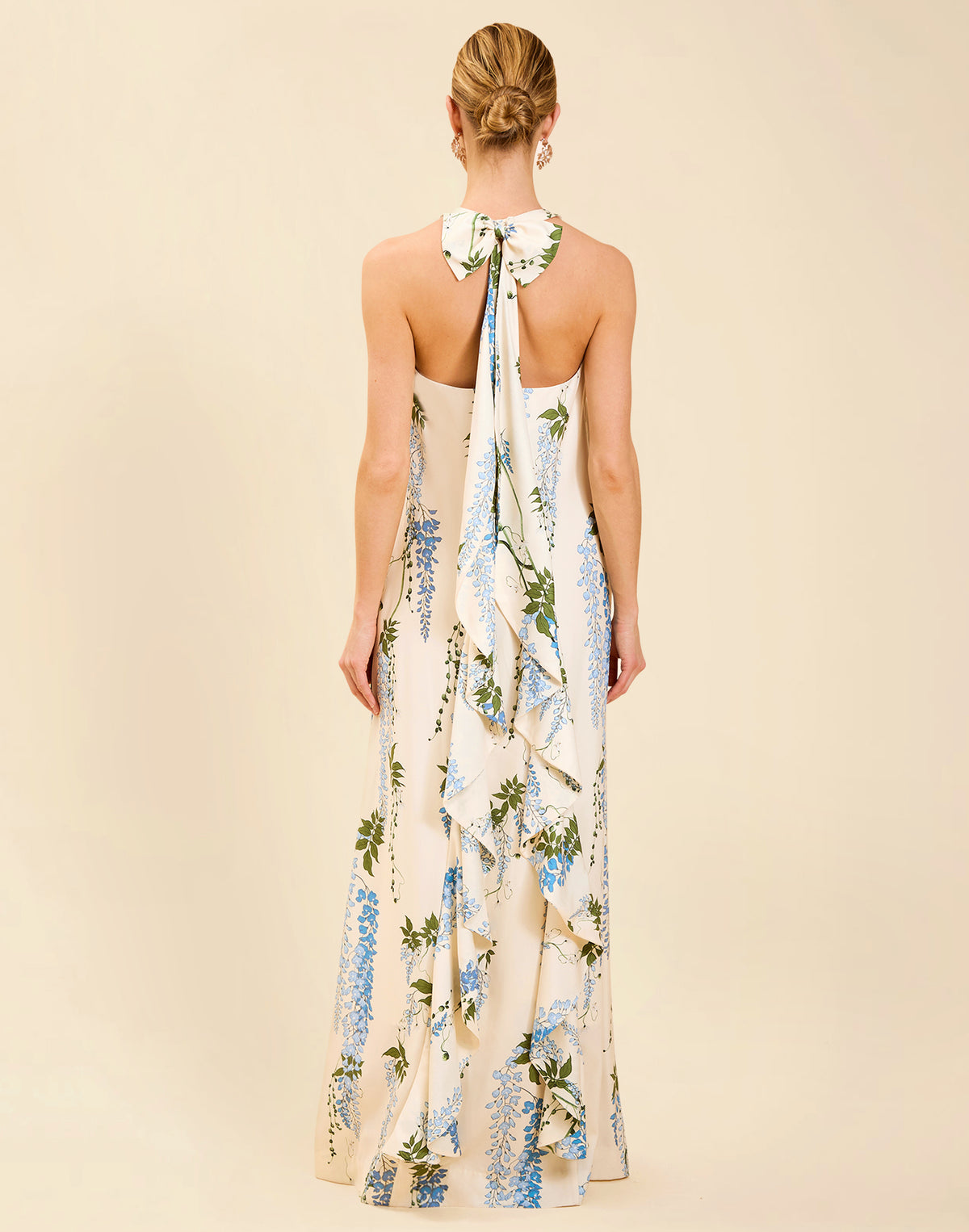 Adelina Gown in Wisteria Toile stretch crepe with halter neckline, cascading bow back detail, A-line silhouette, and hidden side pockets.