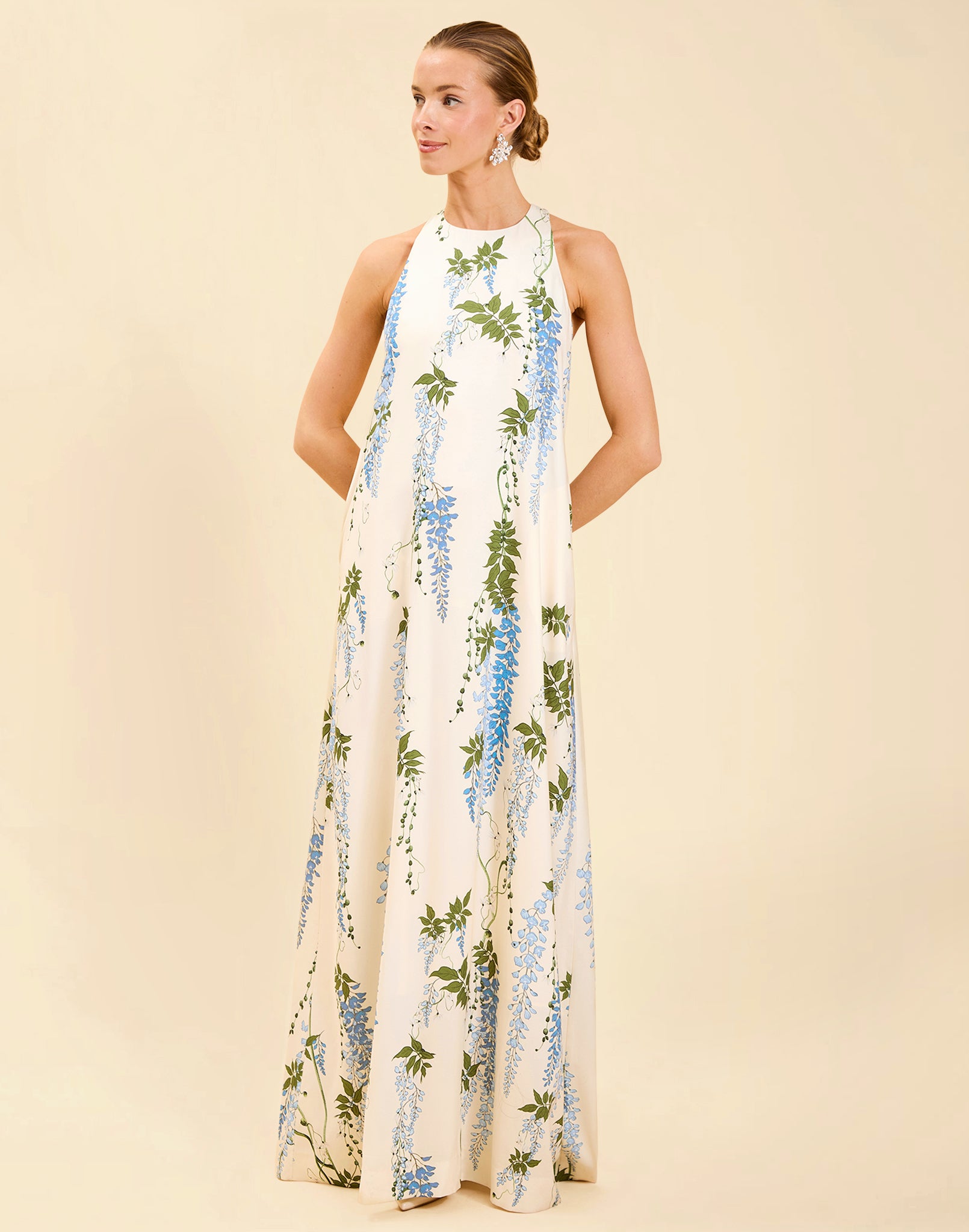 Adelina Gown in Wisteria Toile stretch crepe with halter neckline, cascading bow back detail, A-line silhouette, and hidden side pockets.