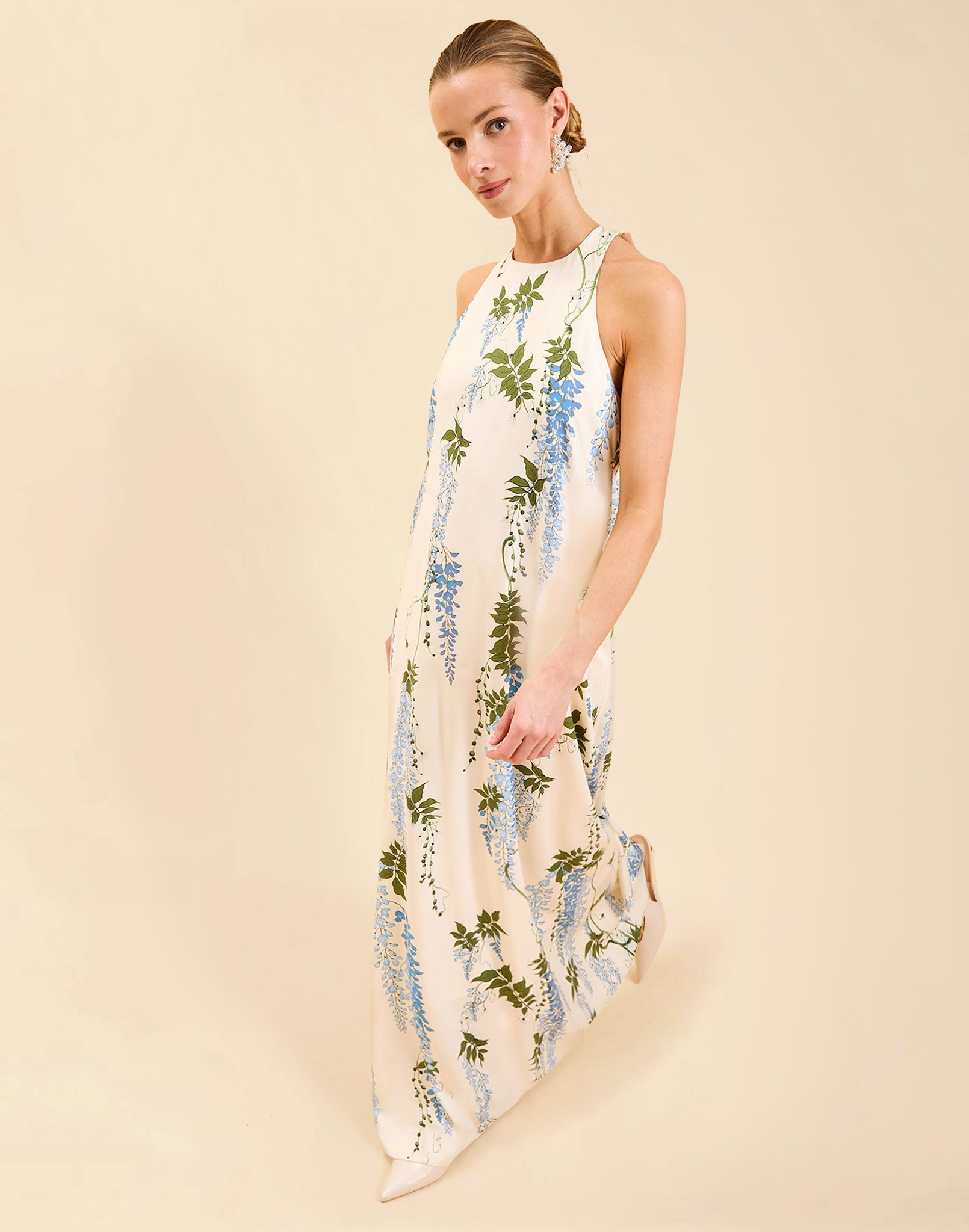 Adelina Gown in Wisteria Toile stretch crepe with halter neckline, cascading bow back detail, A-line silhouette, and hidden side pockets.