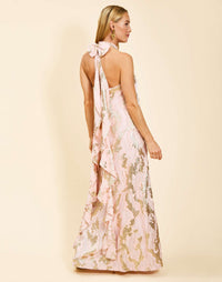 Adelina Gown in Blush Gold metallic jacquard with halter neckline, bow back closure, cascading ruffle detail, and side pockets.