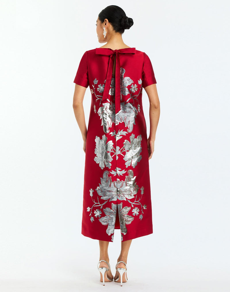 Adria Midi Dress in Burgundy Arbor back – metallic jacquard cocktail midi dress with column silhouette, boat neckline, short sleeves, and bow back detail by Mestiza New York.
