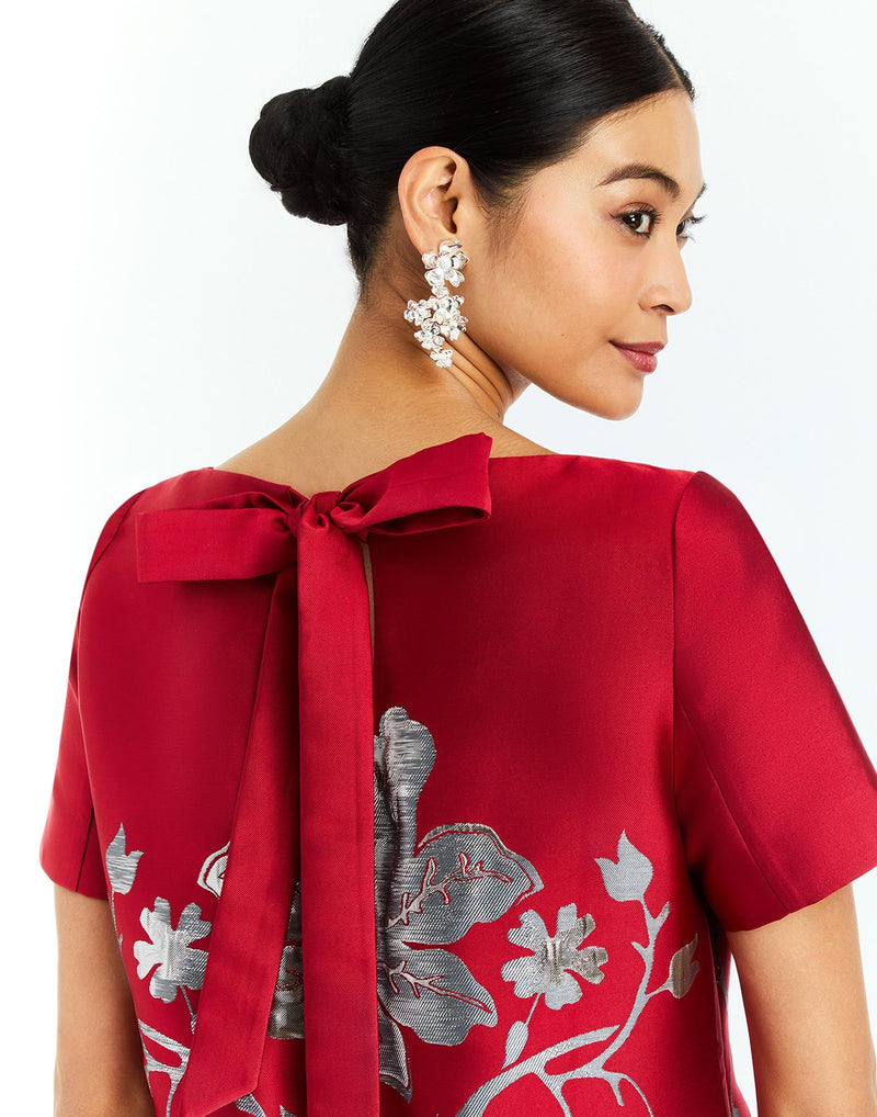 Adria Midi Dress in Burgundy Arbor back – metallic jacquard cocktail midi dress with column silhouette, boat neckline, short sleeves, and bow back detail by Mestiza New York.