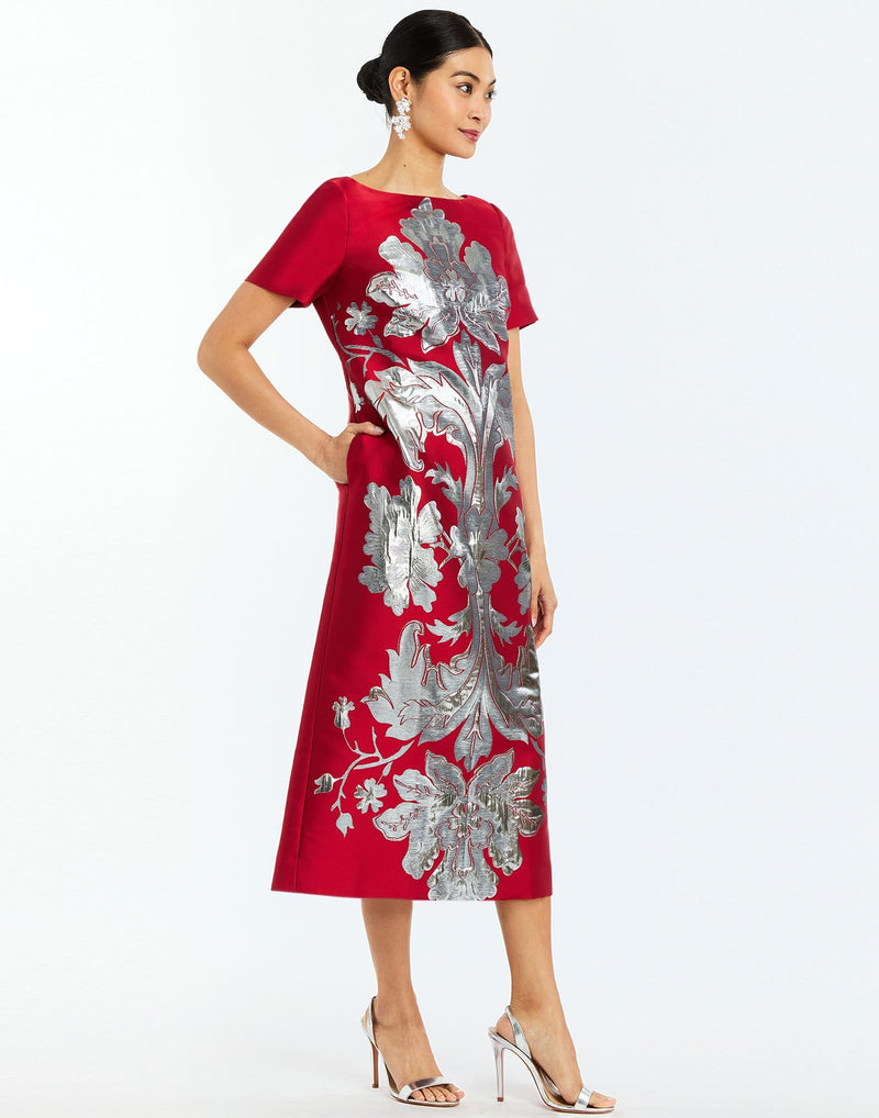 Adria Midi Dress in Burgundy Arbor side – metallic jacquard cocktail midi dress with column silhouette, boat neckline, short sleeves, and bow back detail by Mestiza New York.