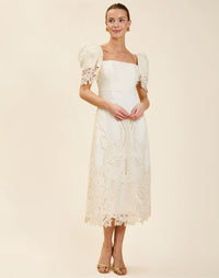 Alessandra Terno Midi Dress in Ivory broderie anglaise lace with sculptural terno sleeves, scalloped neckline, and elegant column midi silhouette.