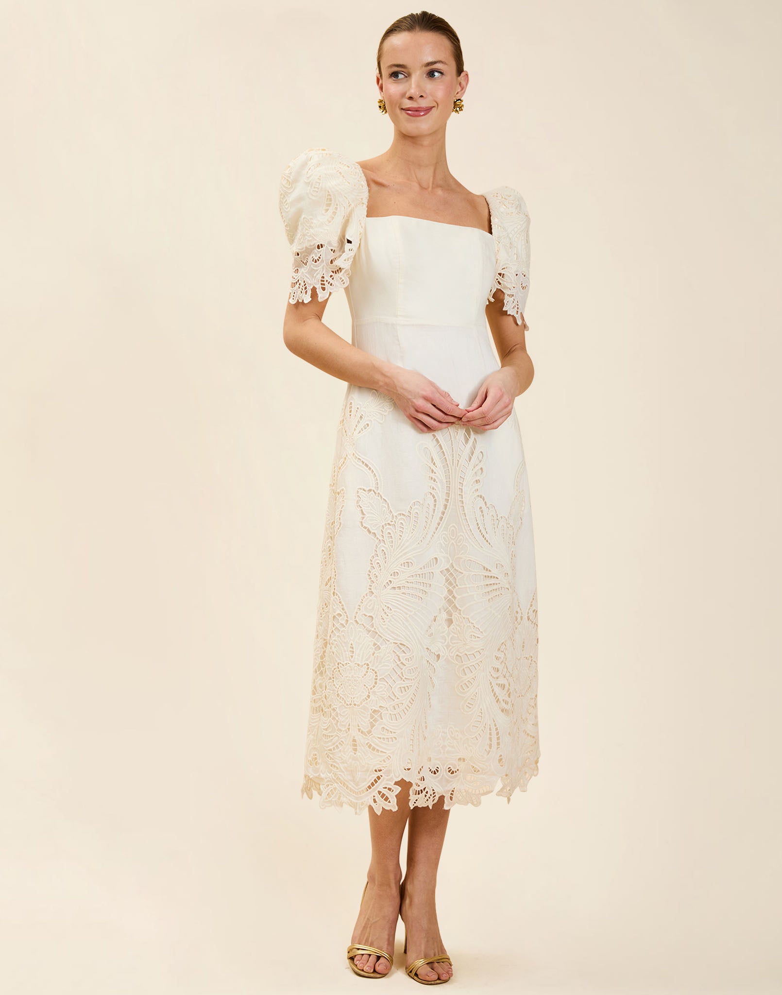 Alessandra Terno Midi Dress in Ivory broderie anglaise lace with sculptural terno sleeves, scalloped neckline, and elegant column midi silhouette.