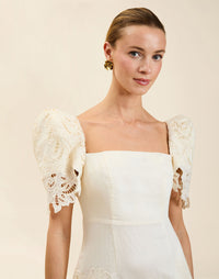 Alessandra Terno Midi Dress in Ivory broderie anglaise lace with sculptural terno sleeves, scalloped neckline, and elegant column midi silhouette.