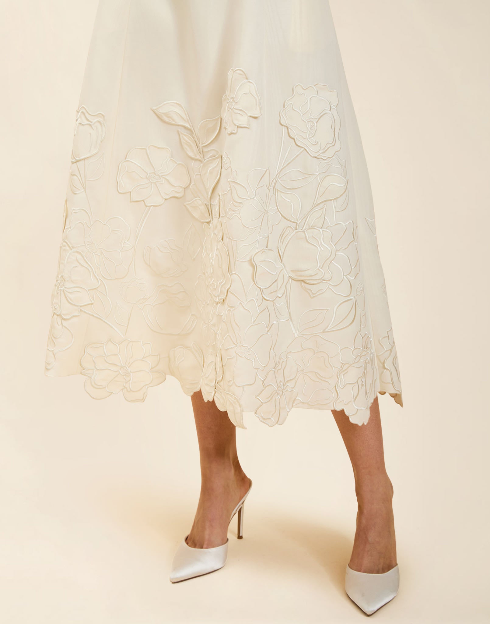 Amanda Midi Dress in Ivory moiré with tonal floral embroidery, scoop neckline, sleeveless bodice, and elegant A-line midi silhouette.