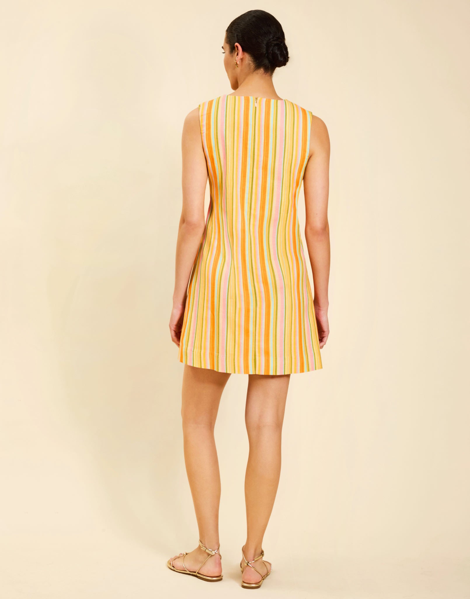 Belize Shift Mini Dress in Sunset Ribbons linen with embroidery detail, notch collar, sleeveless shift silhouette, and side pockets.