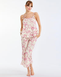 Bella Bow Pajama Set in Ivory/Pink Bows front – printed cotton pajama set with ruffle-hem tank top and pants, elastic waistband, and pockets by Mestiza New York.