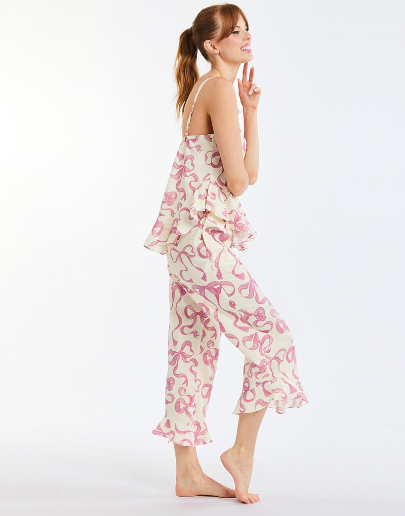 Bella Bow Pajama Set in Ivory/Pink Bows side – printed cotton pajama set with ruffle-hem tank top and pants, elastic waistband, and pockets by Mestiza New York.