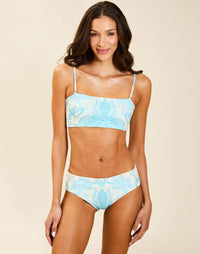 Model wearing Rita Convertible Bikini Bottoms in Grotto Stripe, reversible low-rise swim bottom with subtle cheeky back coverage.