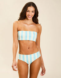 Model wearing Rita Convertible Bikini Bottoms in Grotto Stripe, reversible low-rise swim bottom with subtle cheeky back coverage.