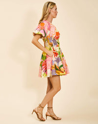 Breakfast Smocked Mini Dress in Primrose Midnight poplin with boat neckline, smocked bodice, balloon sleeves, and side pockets.