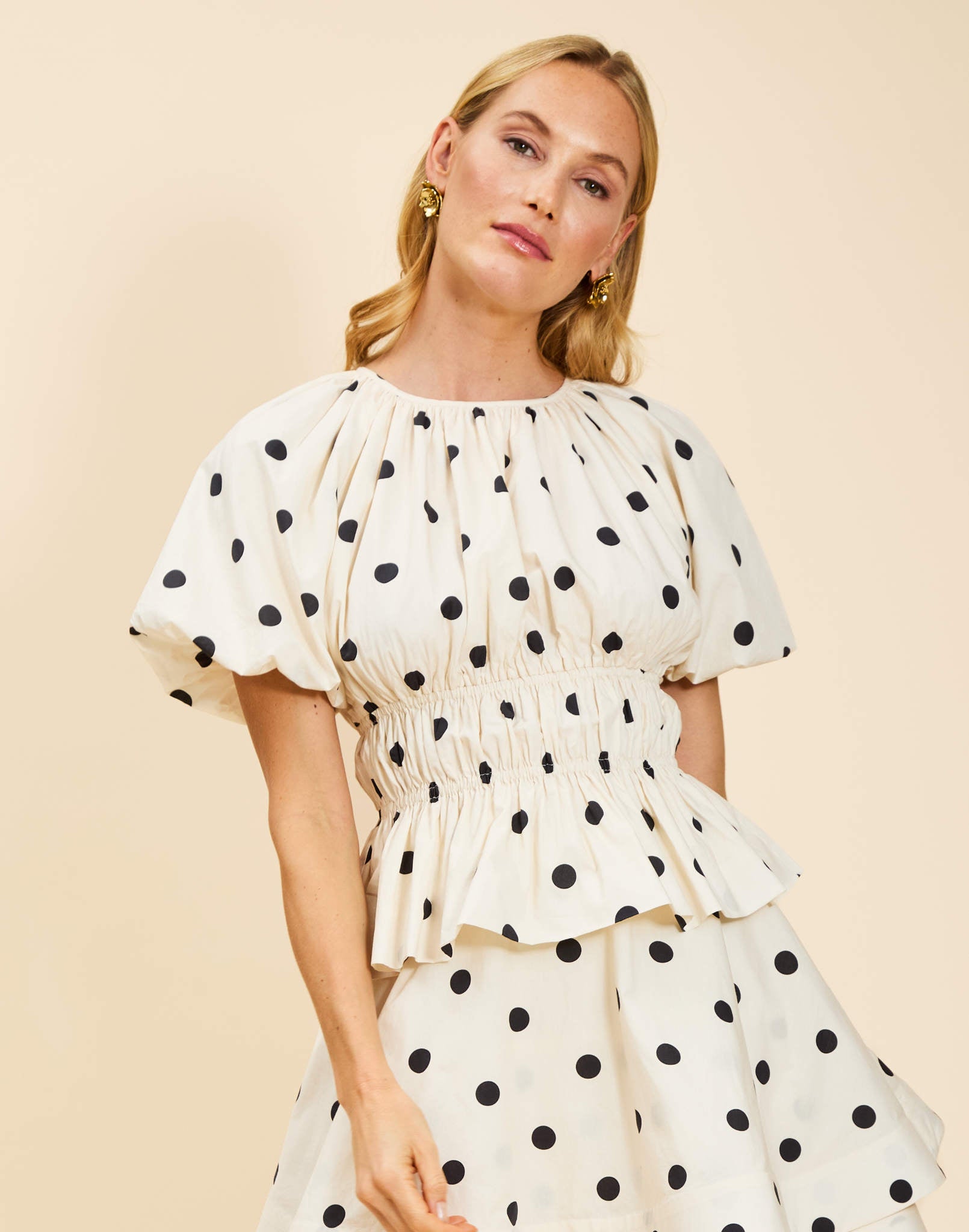 Breakfast Smocked Top in Polka Dot poplin with boat neckline, smocked bodice, balloon sleeves, and peplum hem.