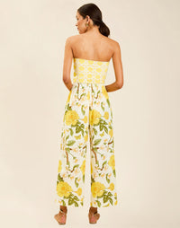 Model wearing Chloe Wrap Beach Pant in Golden Gardenia cotton-linen blend with wraparound panel and self-tie bow.