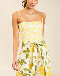 Model wearing Chloe Wrap Beach Pant in Golden Gardenia cotton-linen blend with wraparound panel and self-tie bow.