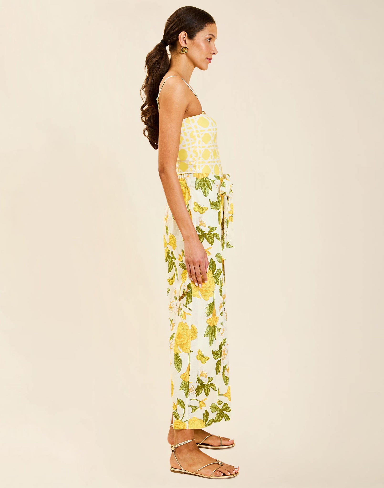 Model wearing Chloe Wrap Beach Pant in Golden Gardenia cotton-linen blend with wraparound panel and self-tie bow.