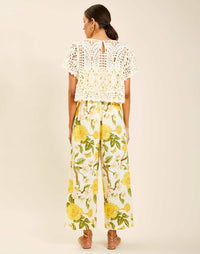 Model wearing Pasay Crochet Top in Ivory with boat neckline and butterfly sleeves in crochet lace.