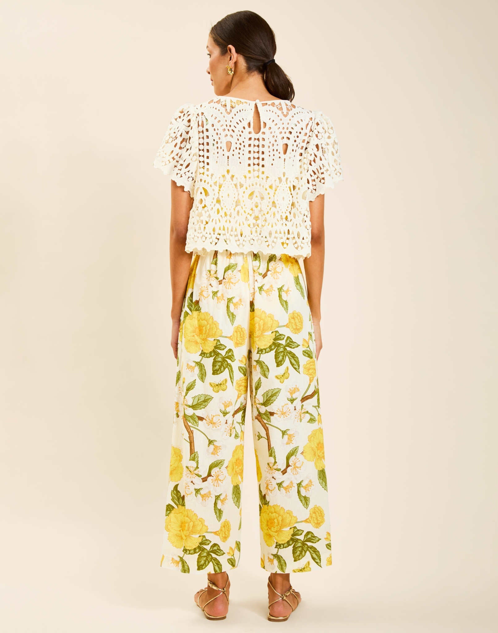 Model wearing Pasay Crochet Top in Ivory with boat neckline and butterfly sleeves in crochet lace.