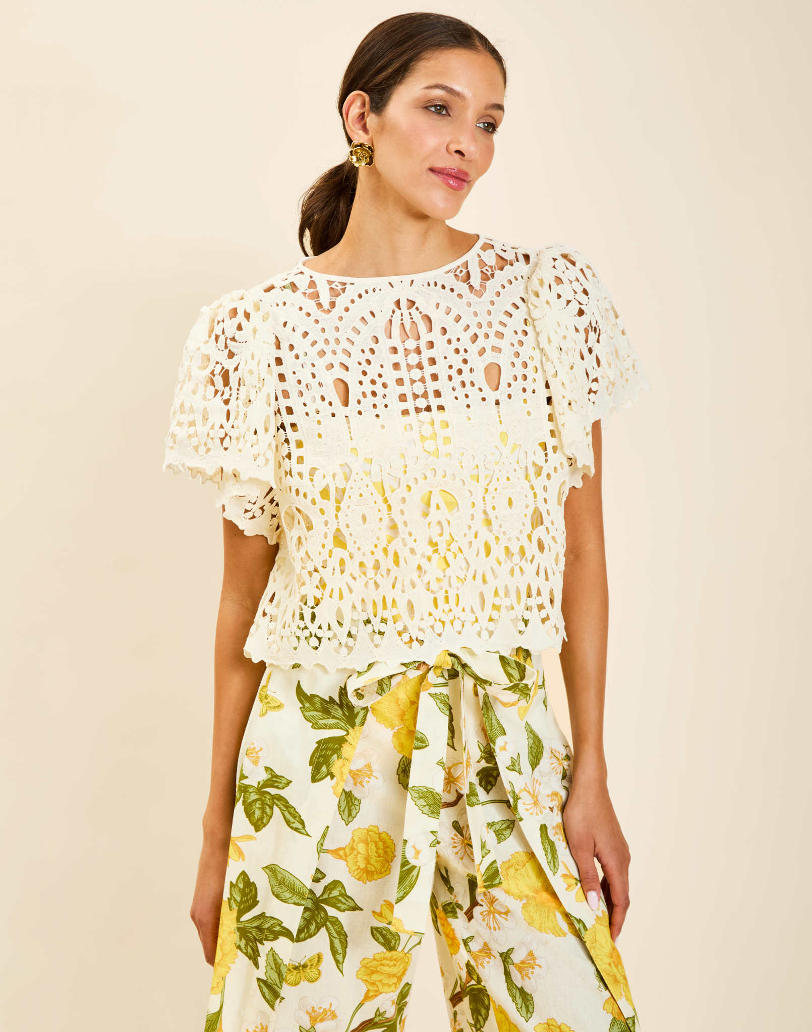 Model wearing Pasay Crochet Top in Ivory with boat neckline and butterfly sleeves in crochet lace.