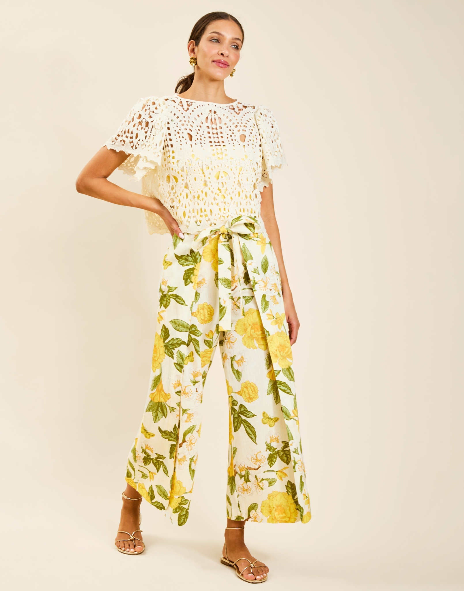 Model wearing Pasay Crochet Top in Ivory with boat neckline and butterfly sleeves in crochet lace.