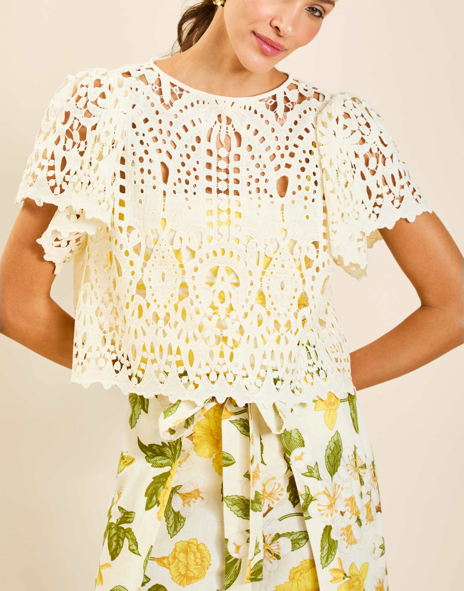 Model wearing Pasay Crochet Top in Ivory with boat neckline and butterfly sleeves in crochet lace.