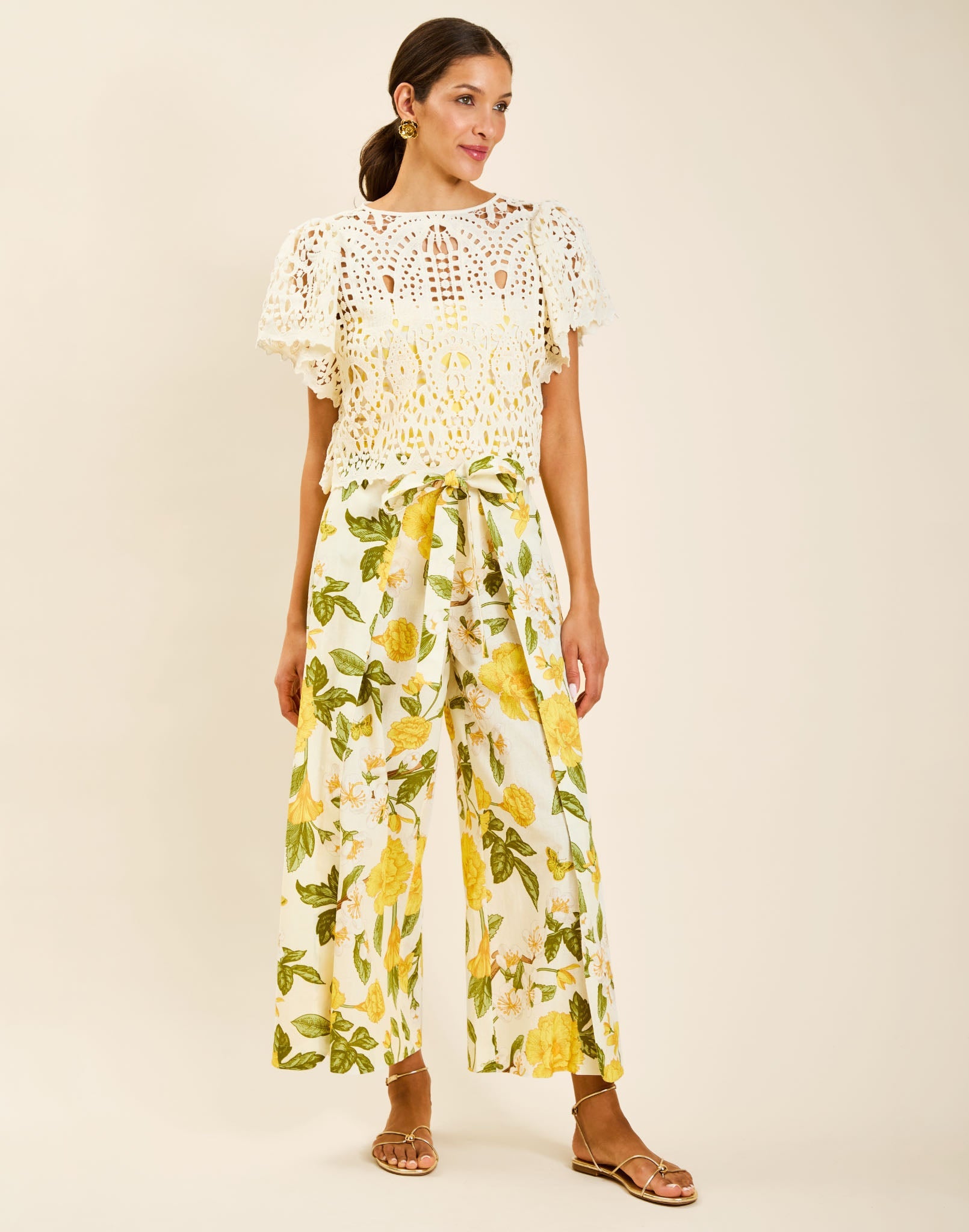 Model wearing Chloe Wrap Beach Pant in Golden Gardenia cotton-linen blend with wraparound panel and self-tie bow.