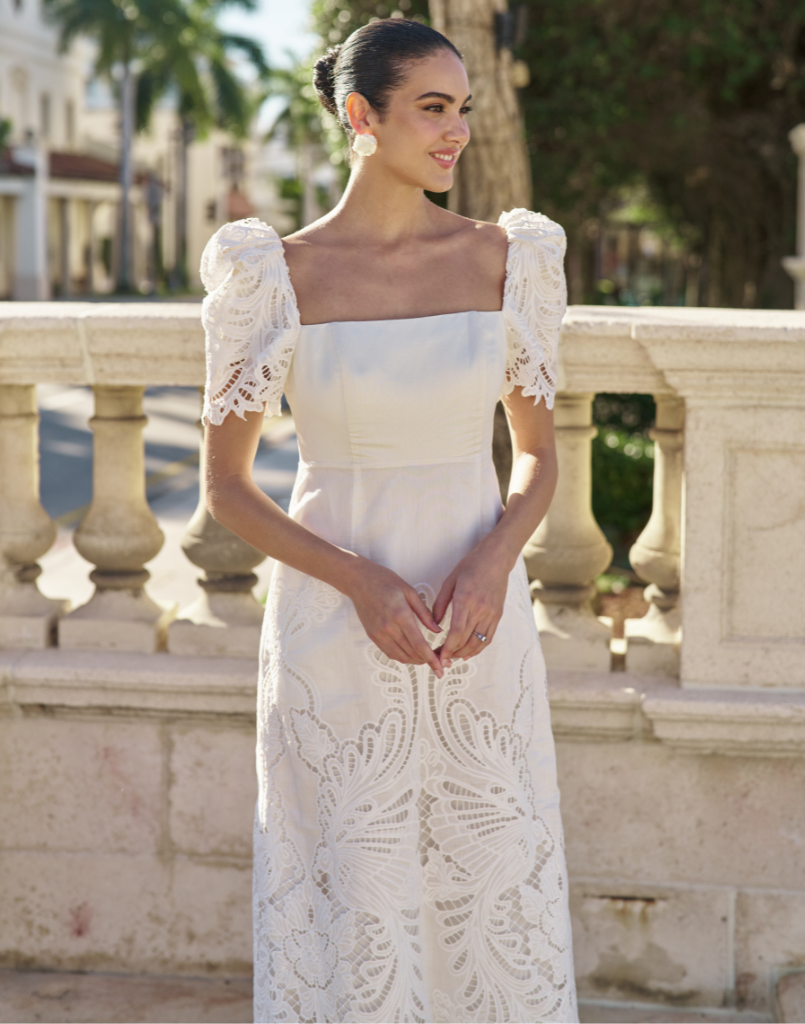 Alessandra Terno Midi Dress in Ivory broderie anglaise lace with sculptural terno sleeves, scalloped neckline, and elegant column midi silhouette.