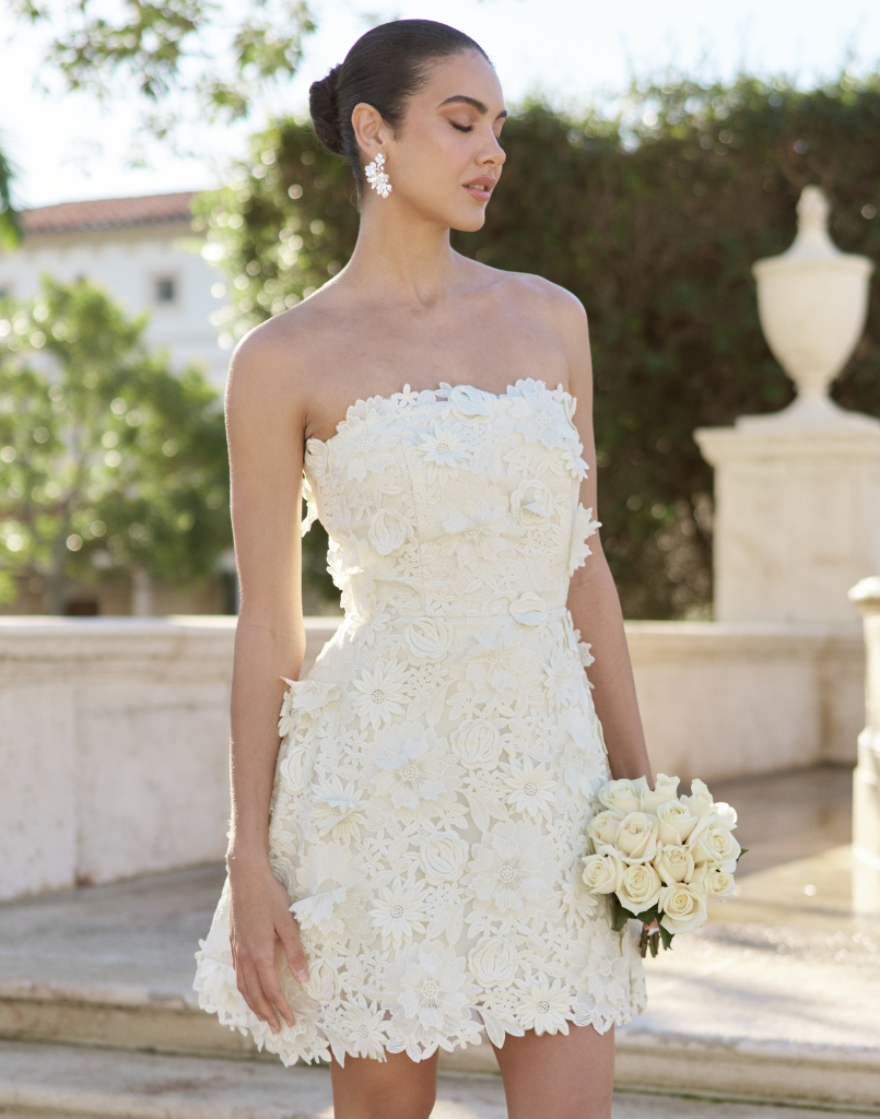 Dottie Lace Mini Dress in Ivory guipure lace with strapless neckline, structured bodice with boning, and bell-skirt mini silhouette.
