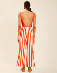 Model wearing Chloe Wrap Beach Pant in Mandarin Stripe cotton-linen blend with wraparound panel and self-tie bow.