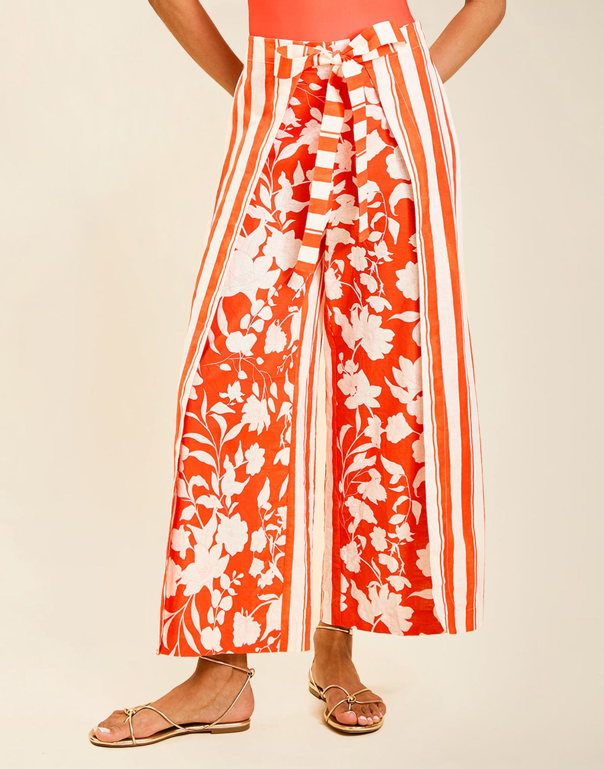 Model wearing Chloe Wrap Beach Pant in Mandarin Stripe cotton-linen blend with wraparound panel and self-tie bow.