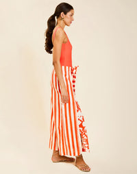 Model wearing Chloe Wrap Beach Pant in Mandarin Stripe cotton-linen blend with wraparound panel and self-tie bow.