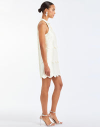 Cannes Convertible™ Mini Dress in Ivory side – cocktail mini dress with scalloped tiers, halter bow neckline, and convertible cropped top styling by Mestiza New York.