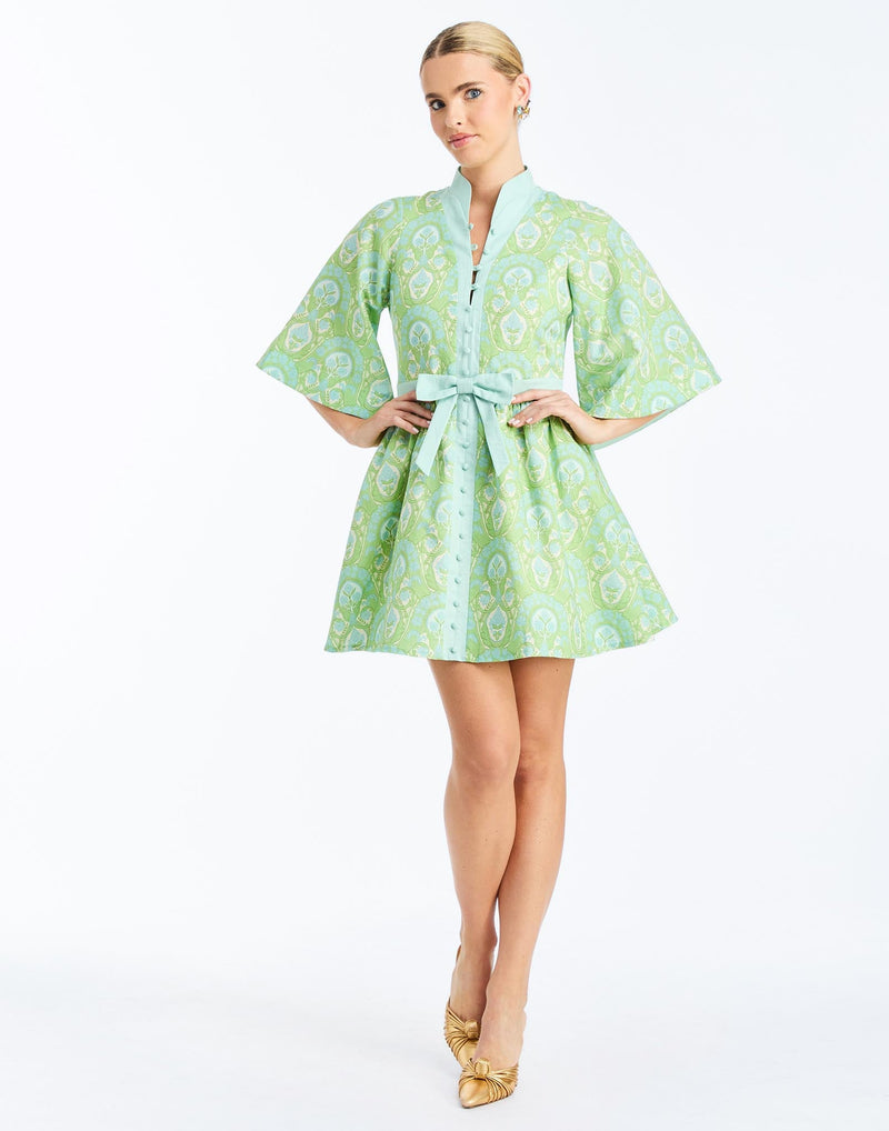 Front - Carmen Mini Dress in Trellis Verte is a printed linen mini with mandarin collar, butterfly sleeves, and waist bow.