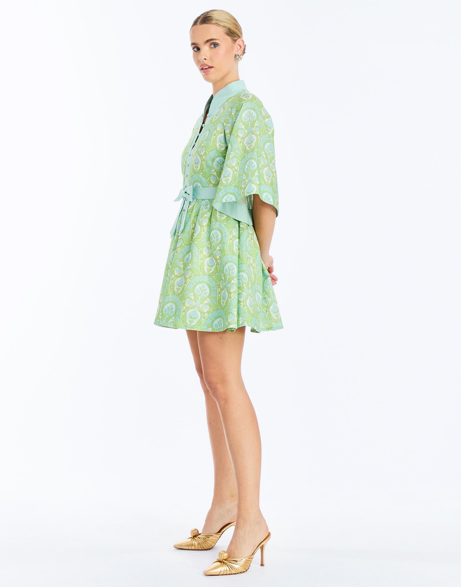 Side - Carmen Mini Dress in Trellis Verte is a printed linen mini with mandarin collar, butterfly sleeves, and waist bow.