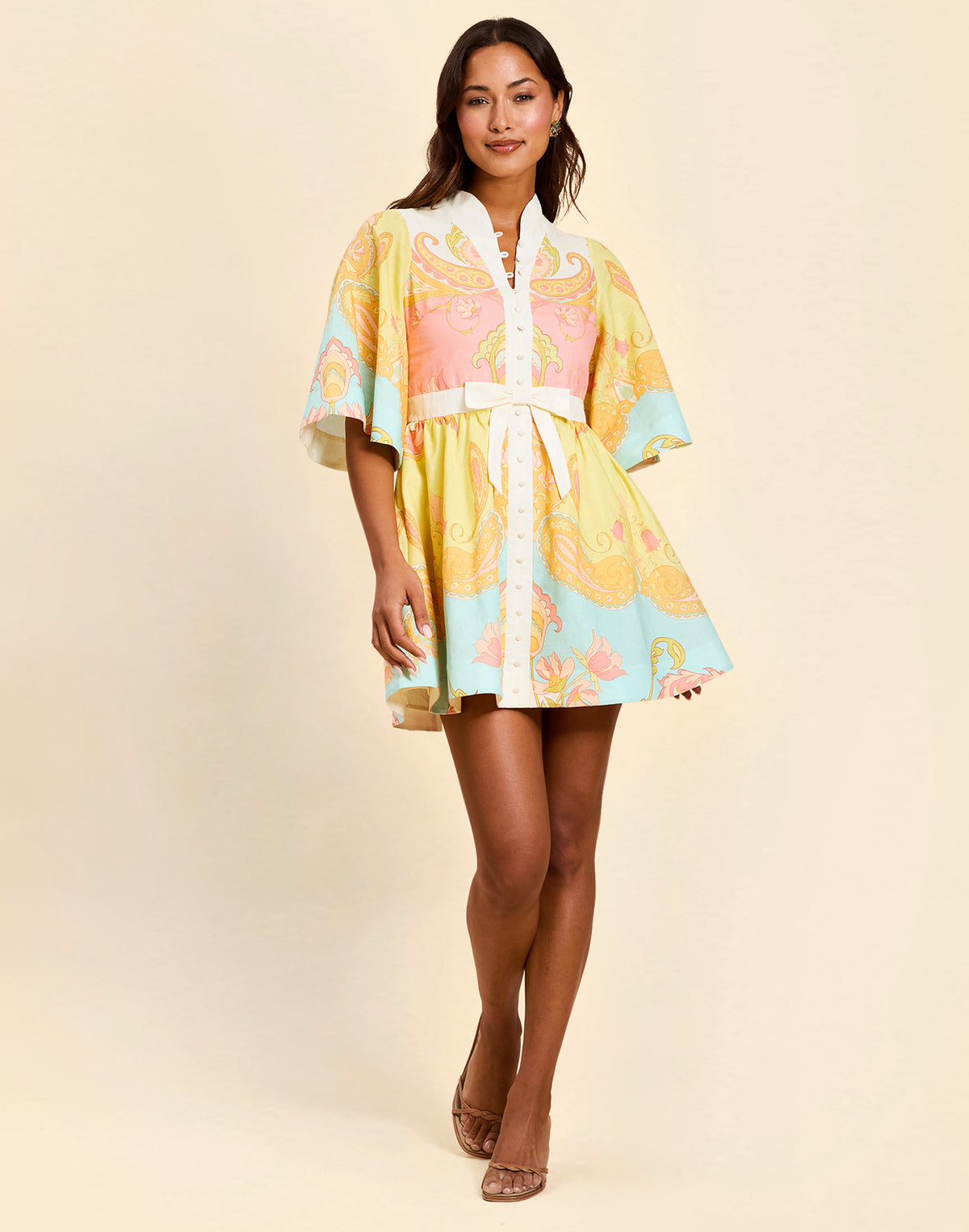 Carmen Mini Dress in Venetian Paisley linen with butterfly sleeves, mandarin collar, and bow waist detail.