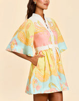 Carmen Mini Dress in Venetian Paisley linen with butterfly sleeves, mandarin collar, and bow waist detail.