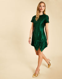 Carter Bow Mini Dress in Emerald Green with a crew neckline, short sleeves, and bow detail framing the front slit.

