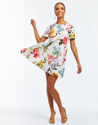 A-line, reversible mini dress with crew neckline and self-tie bow closure. Featuring bold floral print on one side and ocean blue on the reverse side. 