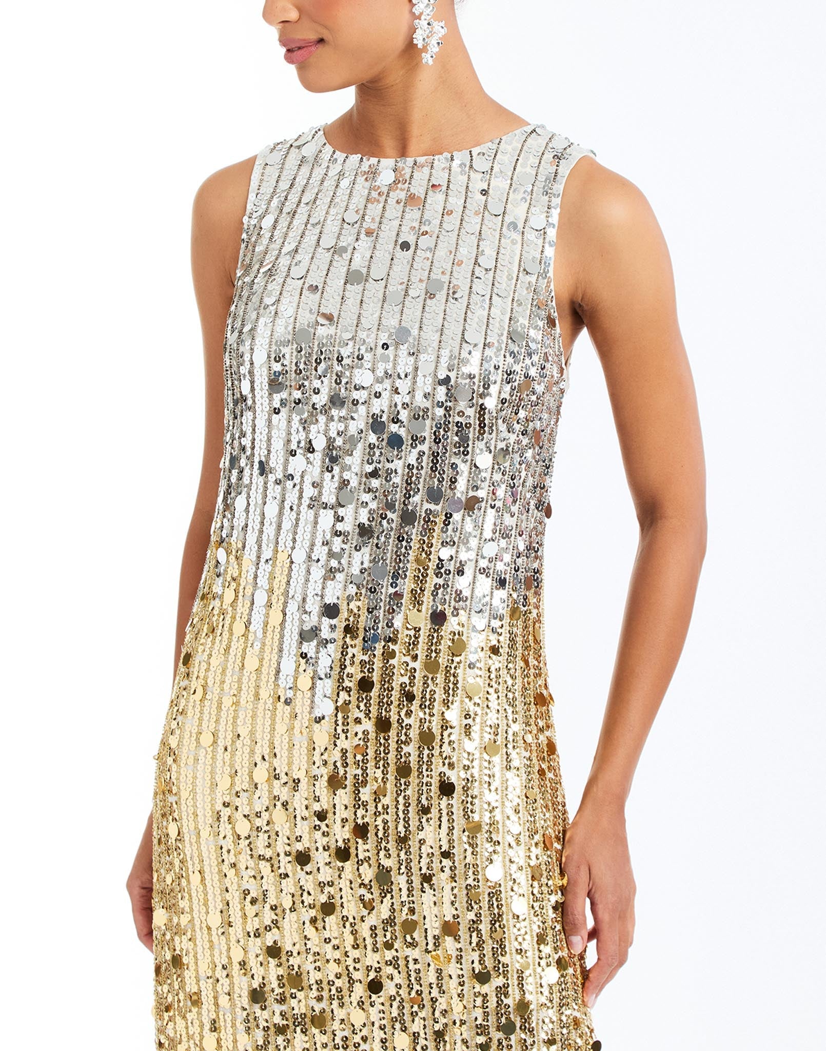 Celestina Sequin Tea Length Dress in Champagne Ombre detail – sleeveless ombre sequin evening dress with crew neckline, organza hem, and column silhouette by Mestiza New York.