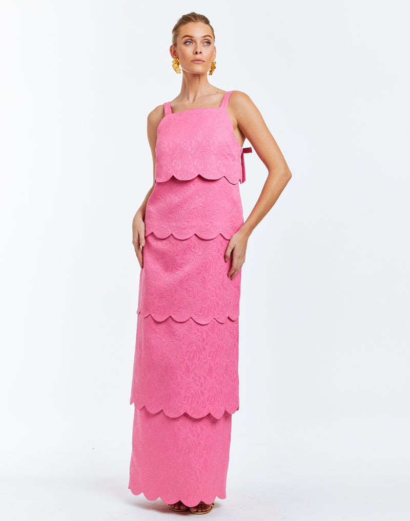 Pink dress with 4 convertible capabilities: gown, midi, min and top. Scalloped tiers and micro bow details at rear base of shoulder straps.